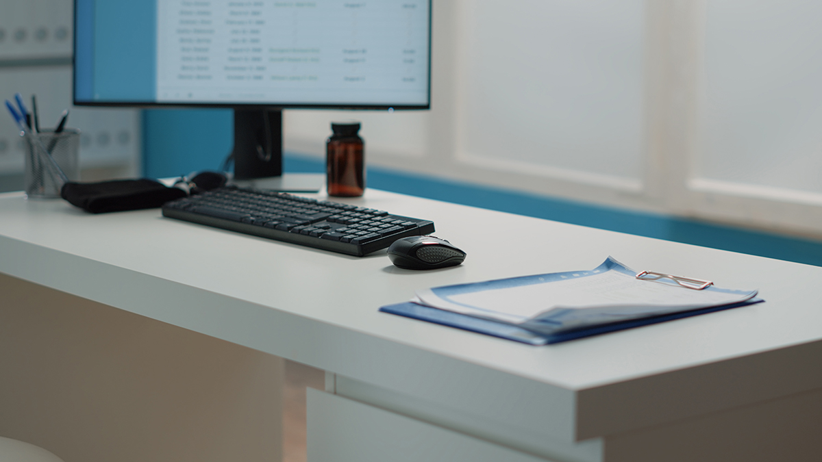 Close up of desk with medical documents and computer